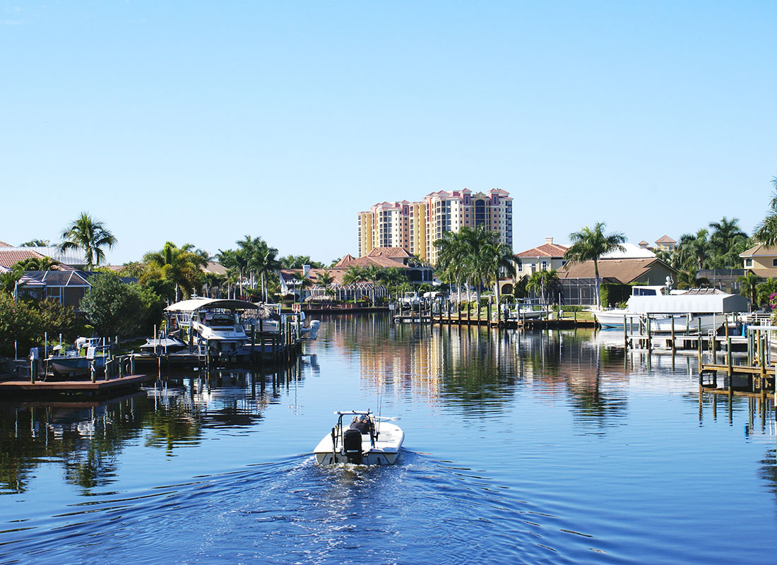Tampa, FL - View of a Boat on the Water Surrounded by Waterfront Homes with Private Boat Docks in Tampa Florida