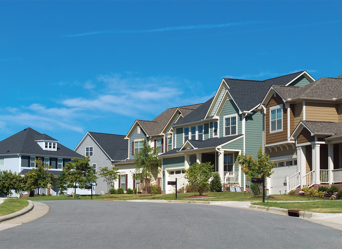 Palm Bay FL - Row of Houses Residential Street Curving Road Blue Sky